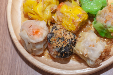 Chinese Steamed Dumpling or Shumai on wooden plate