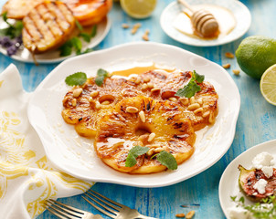 Pineapple dessert, Grilled slices of pineapple with the addition honey, roasted pine nuts,  fresh...