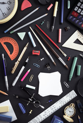 school supplies on black wood