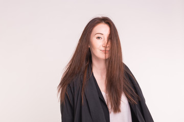 fashion, modeling and people concept - young asian woman looking at something romantic over white background