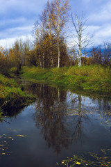 Fototapeta na wymiar Autumn landscape in a heavily weathered river