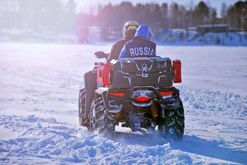 Quad bike on a winter road. Siberian extreme in winter on a quad