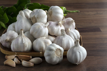 Garlic bulb and cloves in bamboo tray weave