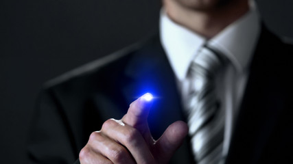 Businessman in suit touching screen, business concept, place for your text