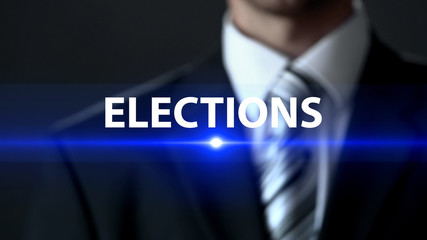 Elections, politician in suit standing in front of screen, political campaign