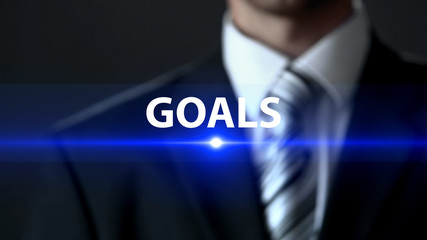 Goals, businessman wearing official suit standing in front of screen, motivation