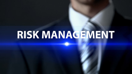 Risk management, businessman in suit standing in front of screen, consulting