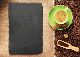 cup of coffee and beans on wooden background