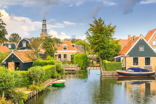 Yndyk, Hindeloopen, province of Friesland,  municipality S&uacute;dwest-Frysl&acirc;n, Netherlands, september 3, 2017:  View to houses and boats at canal Yndyk seen from bridge at Nieuwe Weide