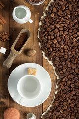 coffee beans and cup on wooden background
