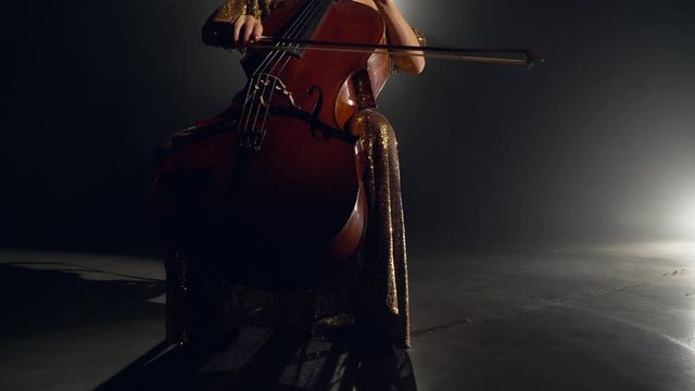 The cellist performs on stage.