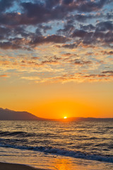 Naklejka premium Early morning , dramatic sunrise over sea and mountain. Photographed in Asprovalta, Greece.