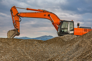 Excavators and heavy machinery in the works of stone movement in a quarry stone extraction for its transformation into gravel