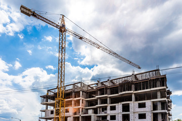 Fototapeta na wymiar construction of a new residential complex with a yellow crane, background image