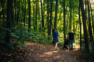 Fototapeta premium happy family with son on background forest.
