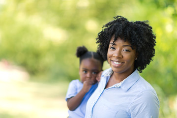 Obraz premium Portrait of an African American mother holding her little girl.