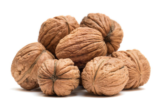 Pile of organic walnuts isolated on white background