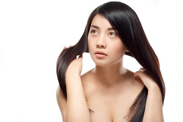 Fototapeta premium portrait of attractive asian model with strong and healthy hair posing isolated on white