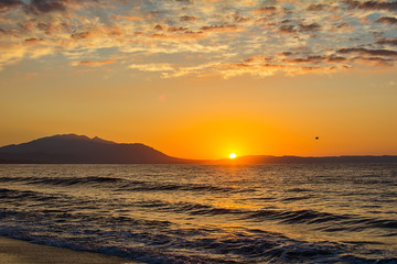 Naklejka premium Early morning , dramatic sunrise over sea and mountain. Photographed in Asprovalta, Greece.
