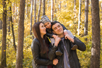 People, family and leisure concept - family having fun standing in autumn park