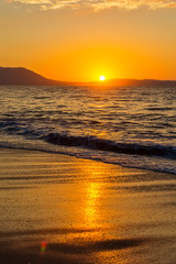 Naklejka premium Early morning , dramatic sunrise over sea and mountain. Photographed in Asprovalta, Greece.