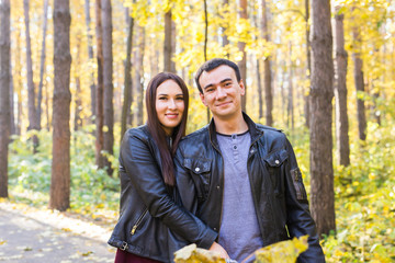 Cute couple outdoors in fall. Young man and woman in autumn nature