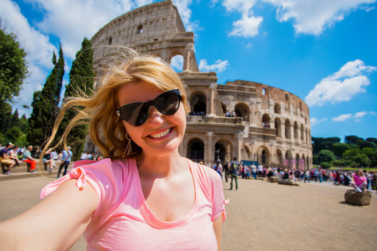 Tourist woman posing in front of Colosseum in Rome