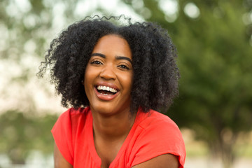 Happy confident African American woman smiling outside.