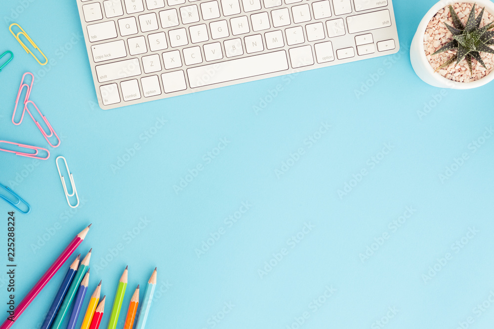 Wall mural flat lay photo of office desk with pencil and keyboard ,top view workpace on blue background and cop