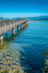 The historical holzsteg pedestrian bridge crossinhg the Upper Zurich Lake (Obersee), part of the old Way of Saint James, Switzerland