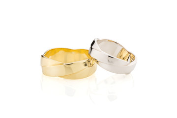 Silver and gold wedding rings intertwined design isolated on white background