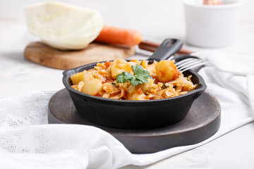 Cabbage stewed with potatoes. Vegetable ragout. Vegan and vegetarian cuisine.