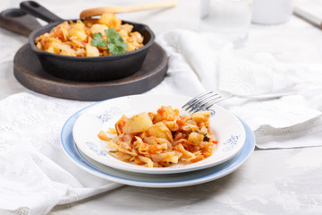 Cabbage stewed with potatoes. Vegetable ragout. Vegan and vegetarian cuisine.