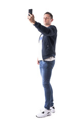 Naklejka premium Adult modern casual man with mobile phone photo messaging. Full body isolated on white background. 