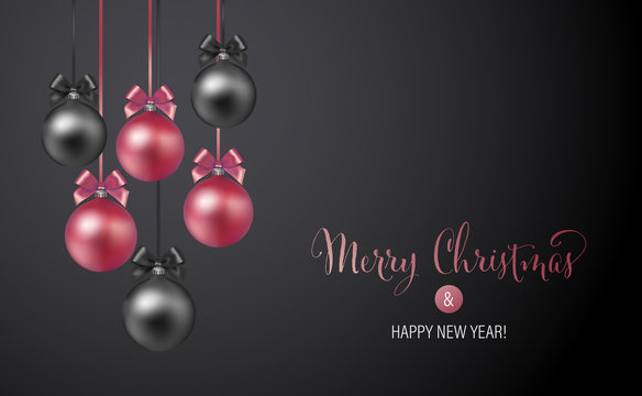 Christmas background with rose and black evening baubles