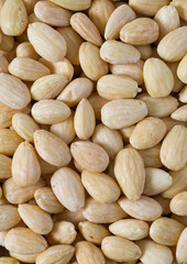 peeled almonds on wooden surface