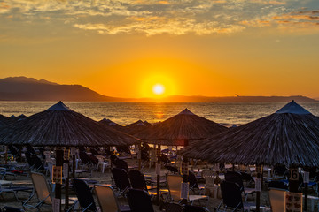 Fototapeta premium View of the sunrise through a local restaurant