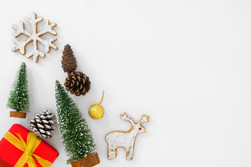 Christmas composition.  Christmas tree and red gift boxes with decoration on white background. Creative flat lay, border and copy space