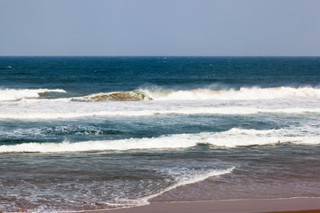 The shoreline at Umhlanga with the waves of the Indian ocean rolling onto the beach, KZN South Africa.