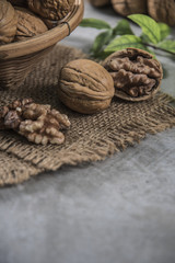 Walnuts in wooden bowl. Whole walnut on table