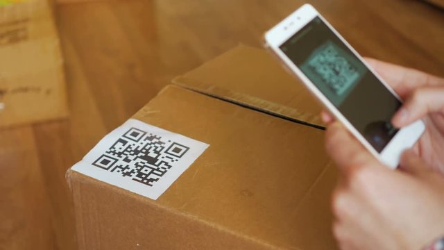 Scanning QR code with smart phone. The man reads the bar code using the application on the smartphone.