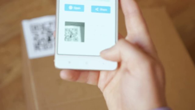 Scanning QR code with smart phone. The man reads the bar code using the application on the smartphone.