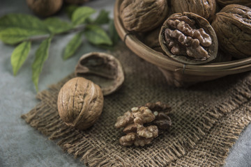 Walnuts in wooden bowl. Whole walnut on table