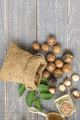 Organic Macadamia nut on wooden table - vintage filter.