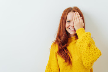 Happy smiling woman covering on eye