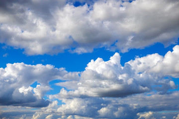 Blue sky background with fluffy clouds