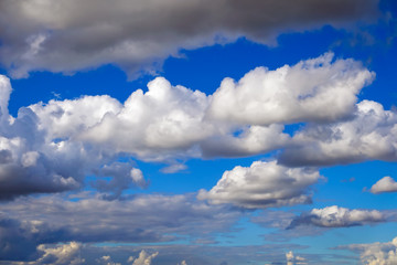 Blue sky background with fluffy clouds