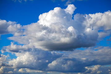 Naklejka na ściany i meble Blue sky background with fluffy clouds