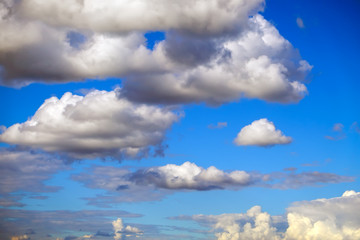 Blue sky background with fluffy clouds
