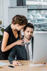 young seductive businesswoman flirting with colleague during work in office